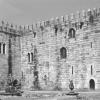 External vie of the Bishop's palace in Braga, with strong crenelated walls and slit windows in the lower floors.