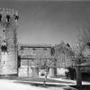 View of the Southern facaded of Monastery of Leça do Balio with a single crenelated tower and clustered buildings and church. 