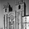Main facade of Porto cathedral with two towers flanking a central panel with the main entrance door and a rose-window.